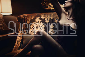 Holly Lancaster offers Bellevue outcalls and poses in a black corset.